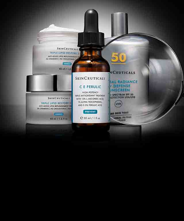 Gros plan sur deux flacons de creme solaire Skinceuticals, un Ultra Facial UV Defense et un Advanced Brightening UV Defense, sur fond noir.