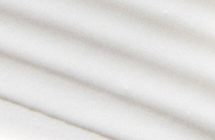 Smooth white surface with soft, flowing curves and subtle shadows.