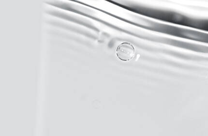 Abstract image of soft, rippling water with subtle wave patterns and light reflections.