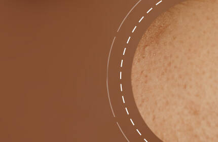 Close-up of textured skin in warm brown tones with a smooth, circular overlay.