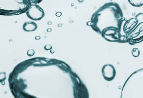 Bulles d'air elegantes flottant dans un liquide clair, creant une ambiance apaisante et transparente.