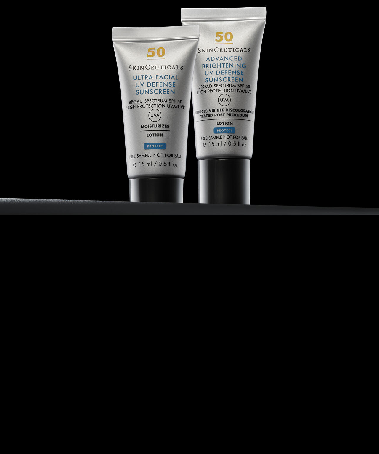 Gros plan sur deux flacons de creme solaire Skinceuticals, un Ultra Facial UV Defense et un Advanced Brightening UV Defense, sur fond noir.