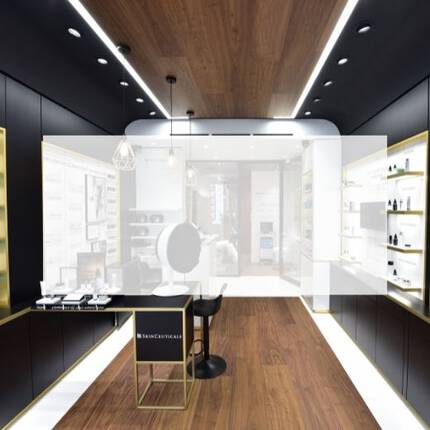 An interior view of a sleek skincare store featuring shelves lined with various beauty products, modern lighting, and informational displays on the walls.
